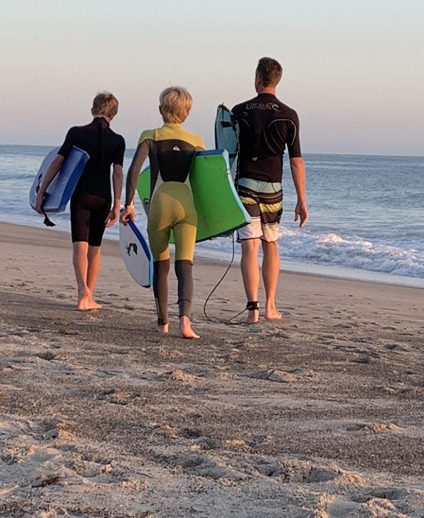 boys and their Dad going surfing