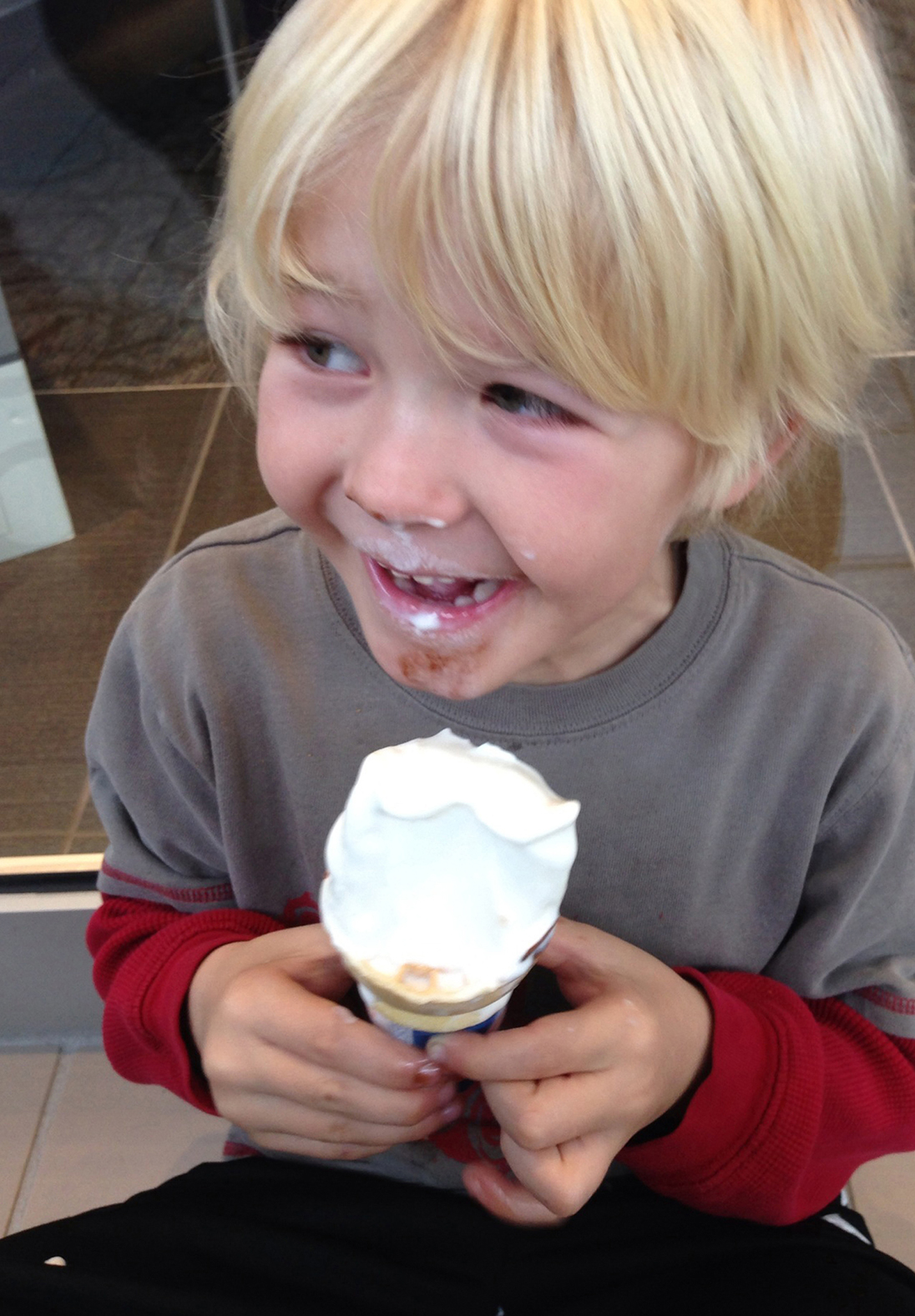 Young boys happily eating ice cream.